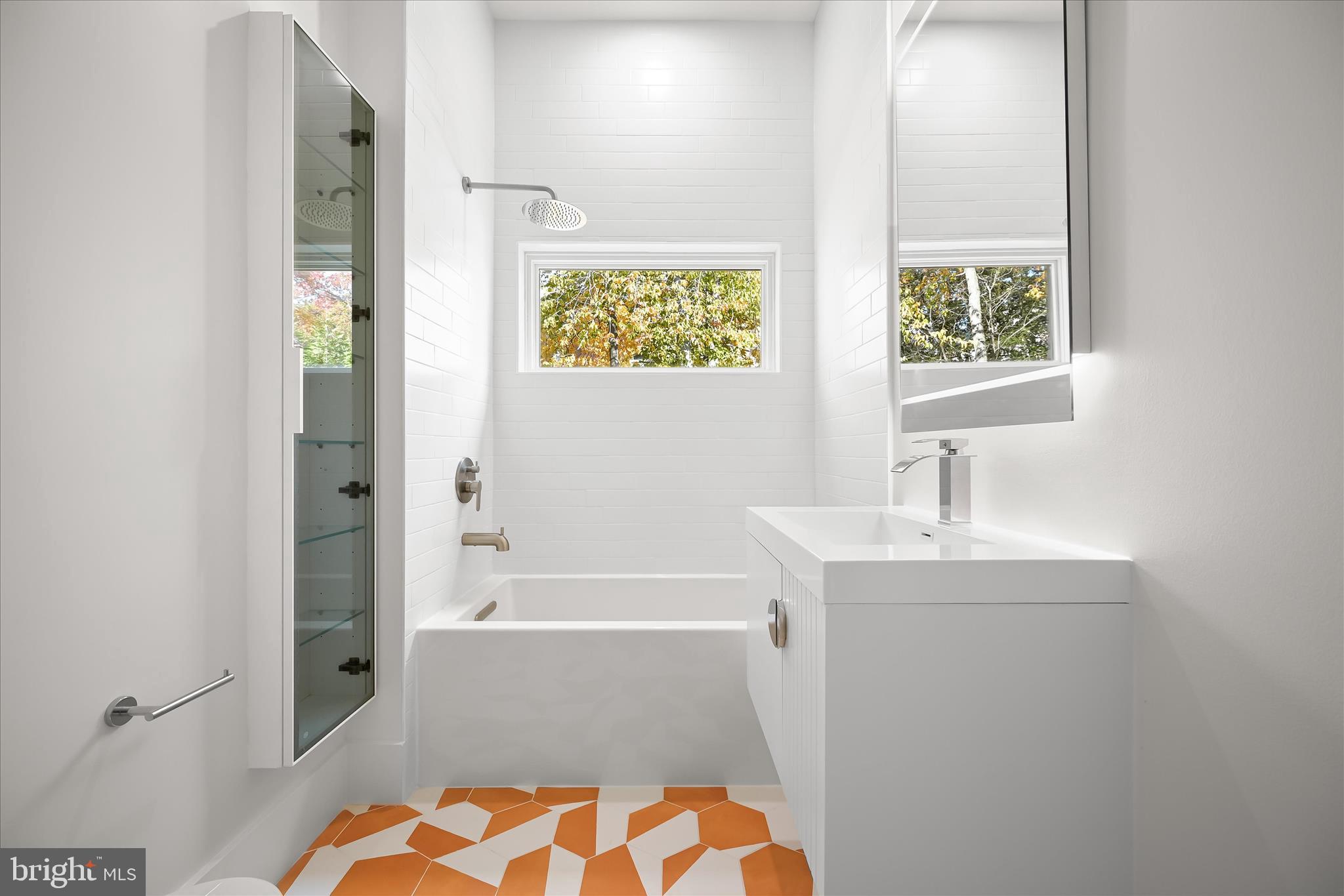 4509 Foxhall Crescent Northwest Washington, DC 20007 - Photo 27 of 39 a bathroom with a sink a bathtub and a window