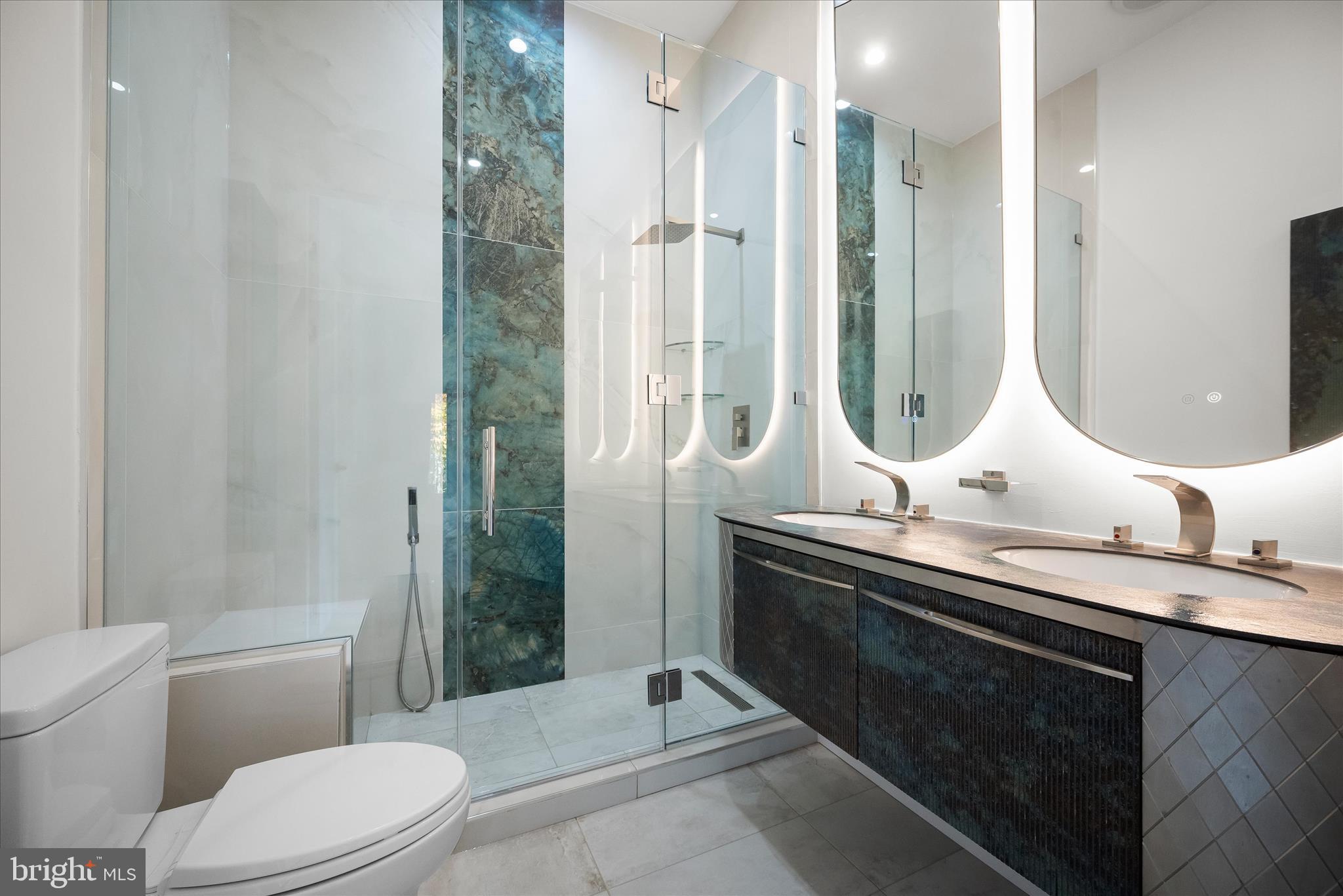 4509 Foxhall Crescent Northwest Washington, DC 20007 - Photo 29 of 39 a bathroom with a double vanity sink toilet and shower