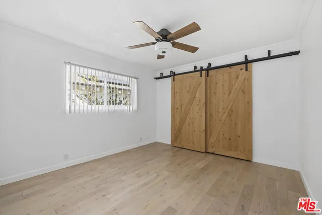 a view of a ceiling fan and a window