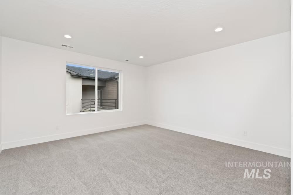744 South Calhoun Lane Star, ID 83669 - Photo 13 of 34 Unfurnished room featuring light colored carpet and recessed lighting