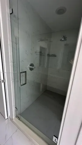 a bathroom with a glass door shower