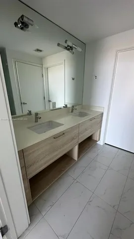 a bathroom with a sink a vanity and a mirror