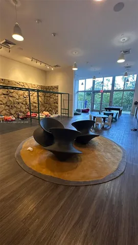 a view of a swimming pool with furniture and floor to ceiling window