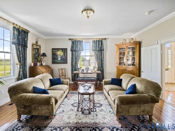 a view of a livingroom with furniture window and wooden floor
