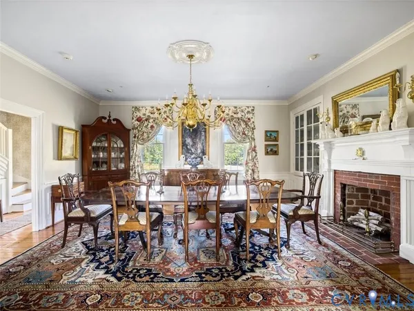 a view of a dining room with furniture wooden floor and a chandelier
