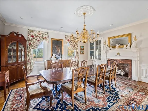 a view of a dining room with furniture and chandelier