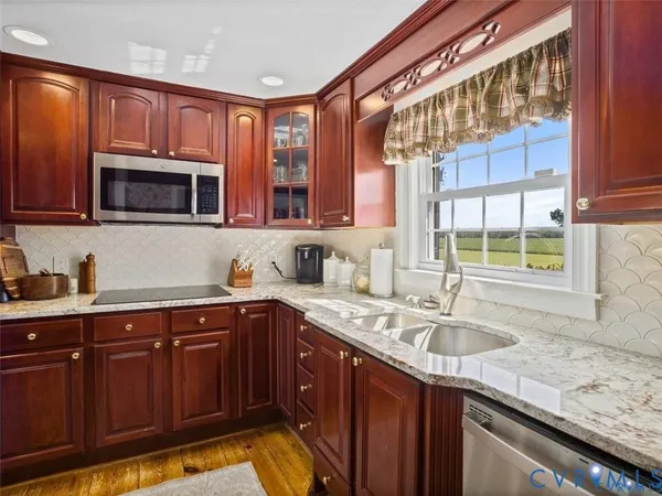 a kitchen with stainless steel appliances granite countertop a refrigerator and microwave