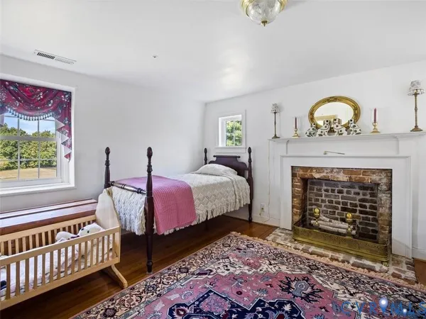a spacious bedroom with a bed and a fireplace