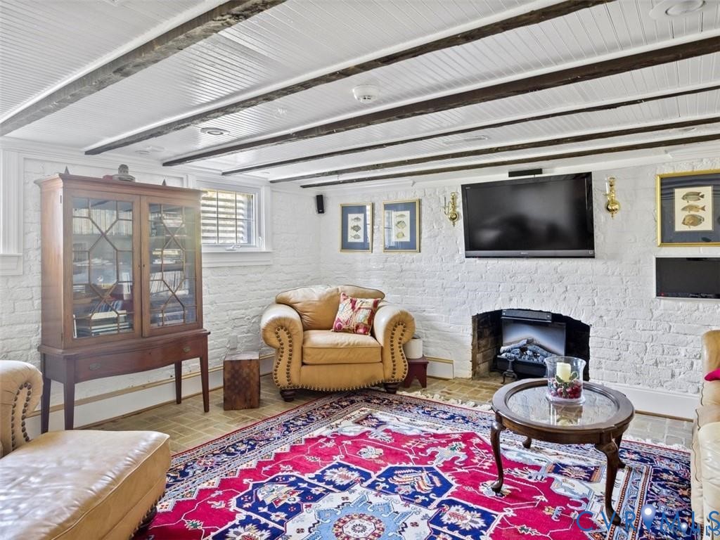 1070 Marlborough Road Bruington, VA 23023 - Photo 37 of 50 a living room with furniture a flat screen tv and a fireplace