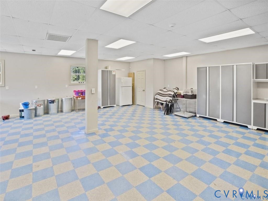 1070 Marlborough Road Bruington, VA 23023 - Photo 45 of 50 a living room with a black white checkered floor with a gaming machine and dining chairs