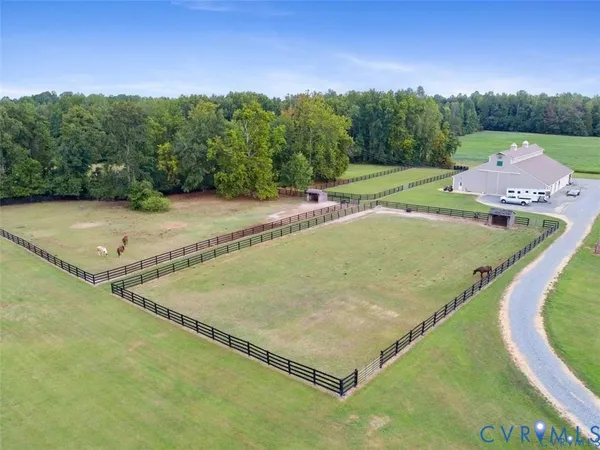 an aerial view of a house with a yard basket ball court and outdoor seating