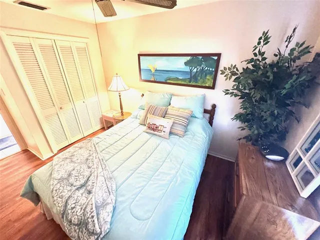 a bedroom with bed and hardwood floor