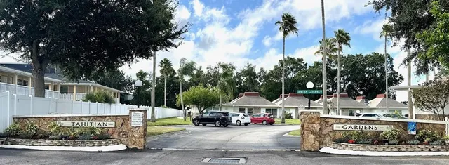a view of a street with cars parked on the road
