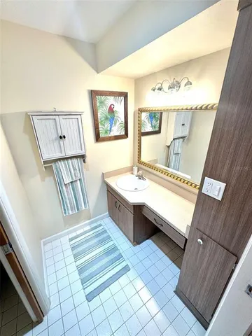 a spacious bathroom with a double vanity sink a mirror and a bathtub