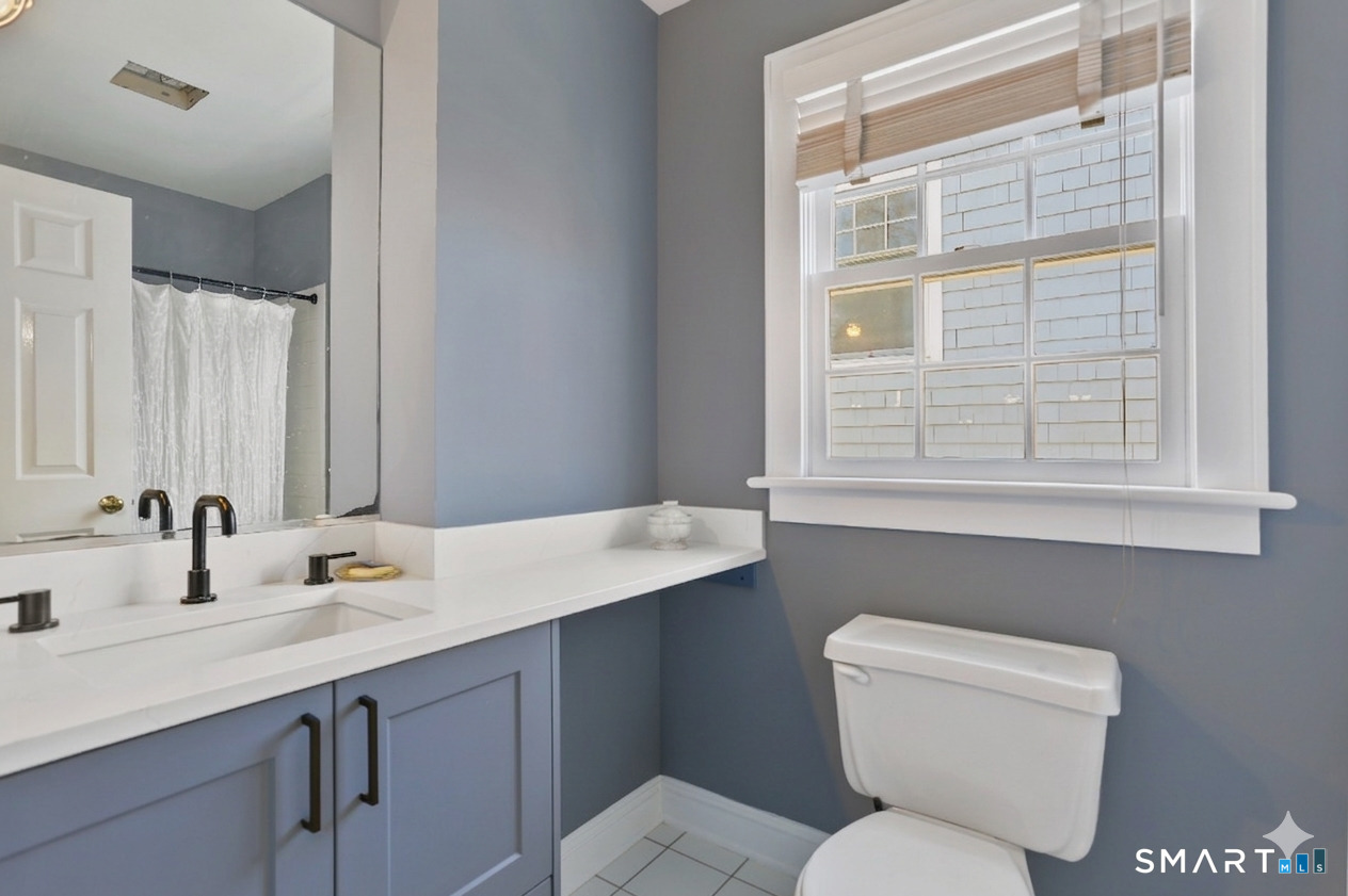 5 Yarmouth Road Norwalk, CT 06853 - Photo 14 of 23 a bathroom with a toilet sink and a window