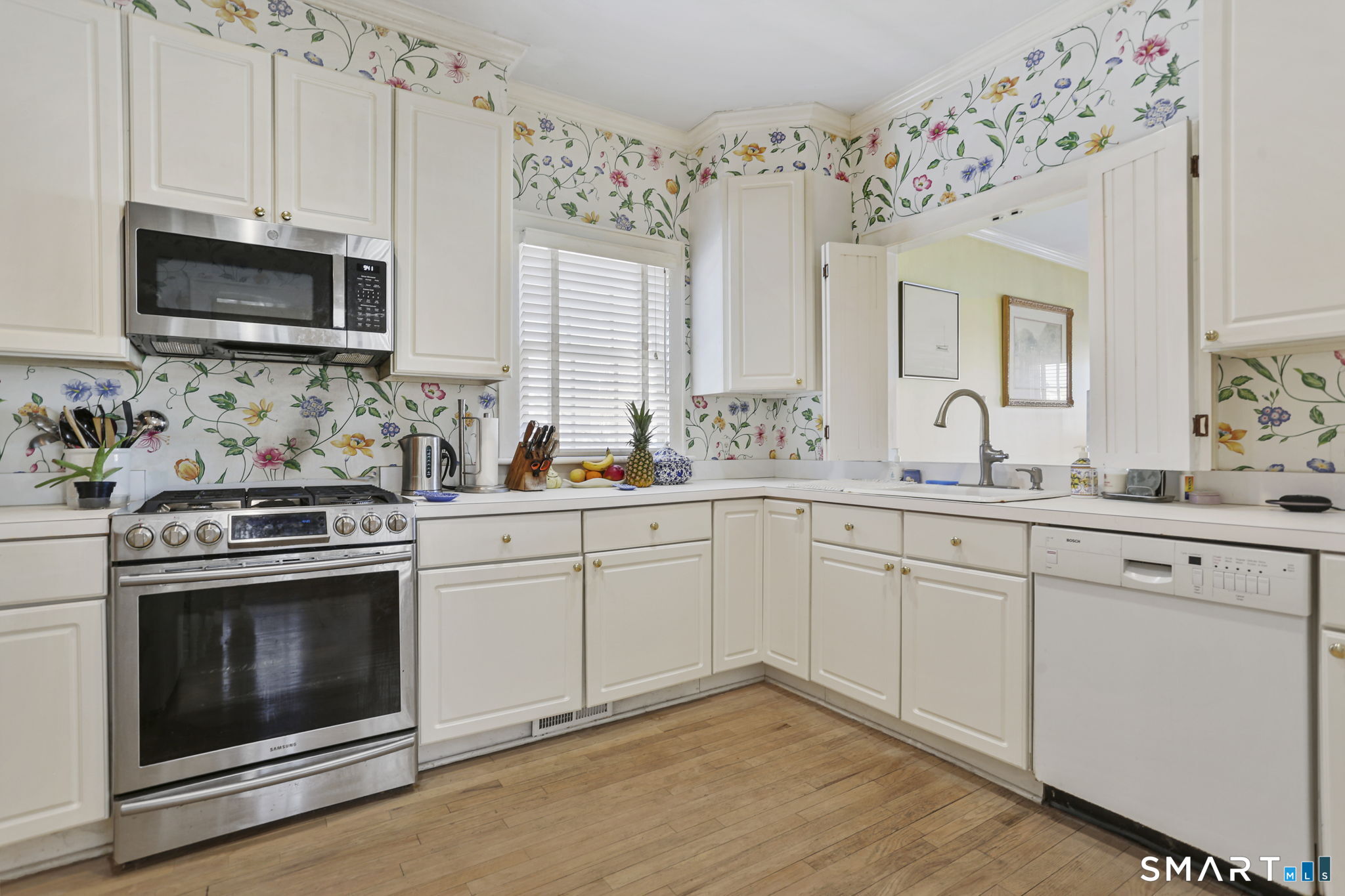 5 Yarmouth Road Norwalk, CT 06853 - Photo 9 of 23 a kitchen with granite countertop white cabinets stainless steel appliances and sink