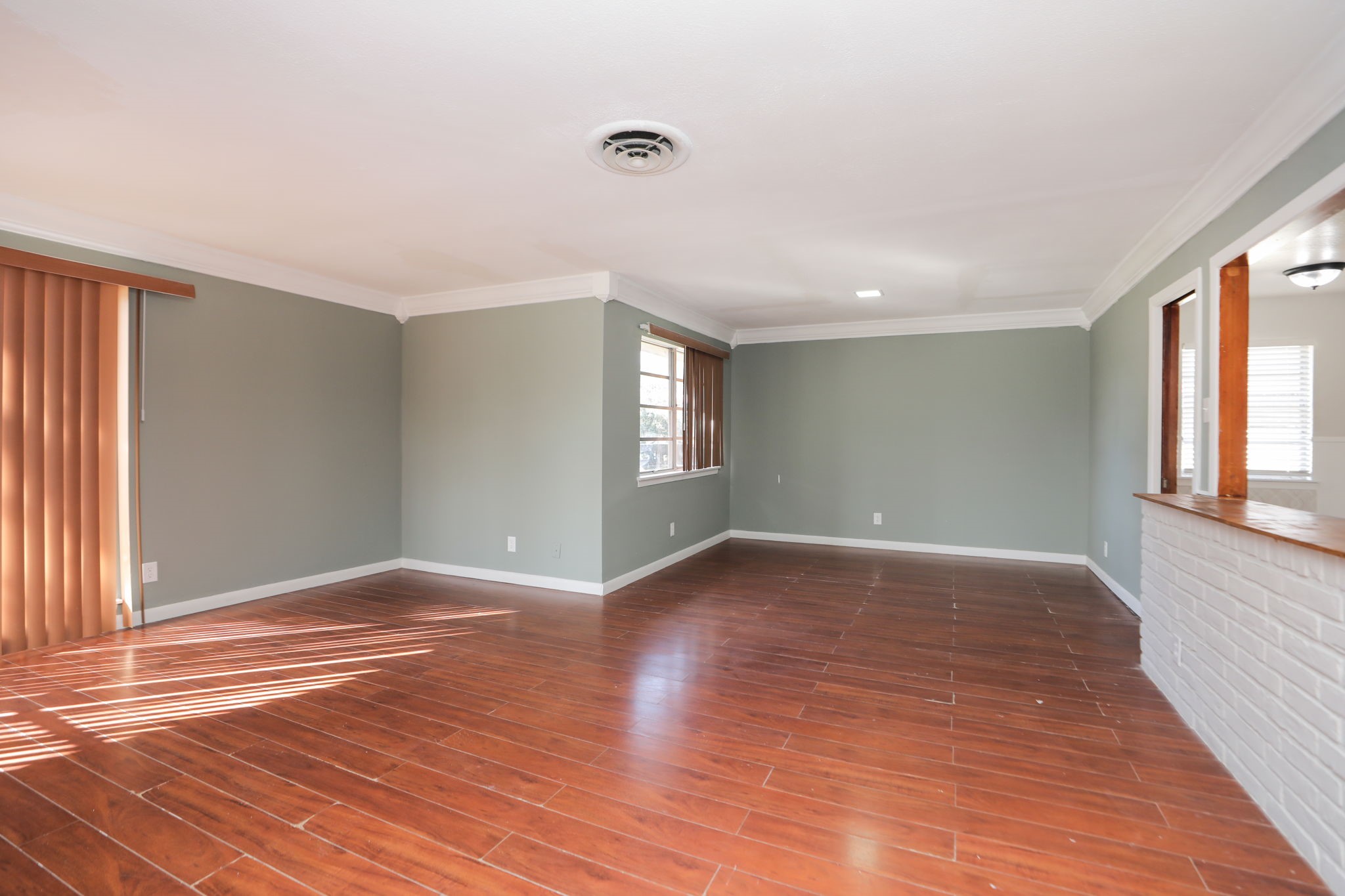 8235 Dover Street Houston, TX 77061 - Photo 6 of 36 a view of an empty room with wooden floor and a window