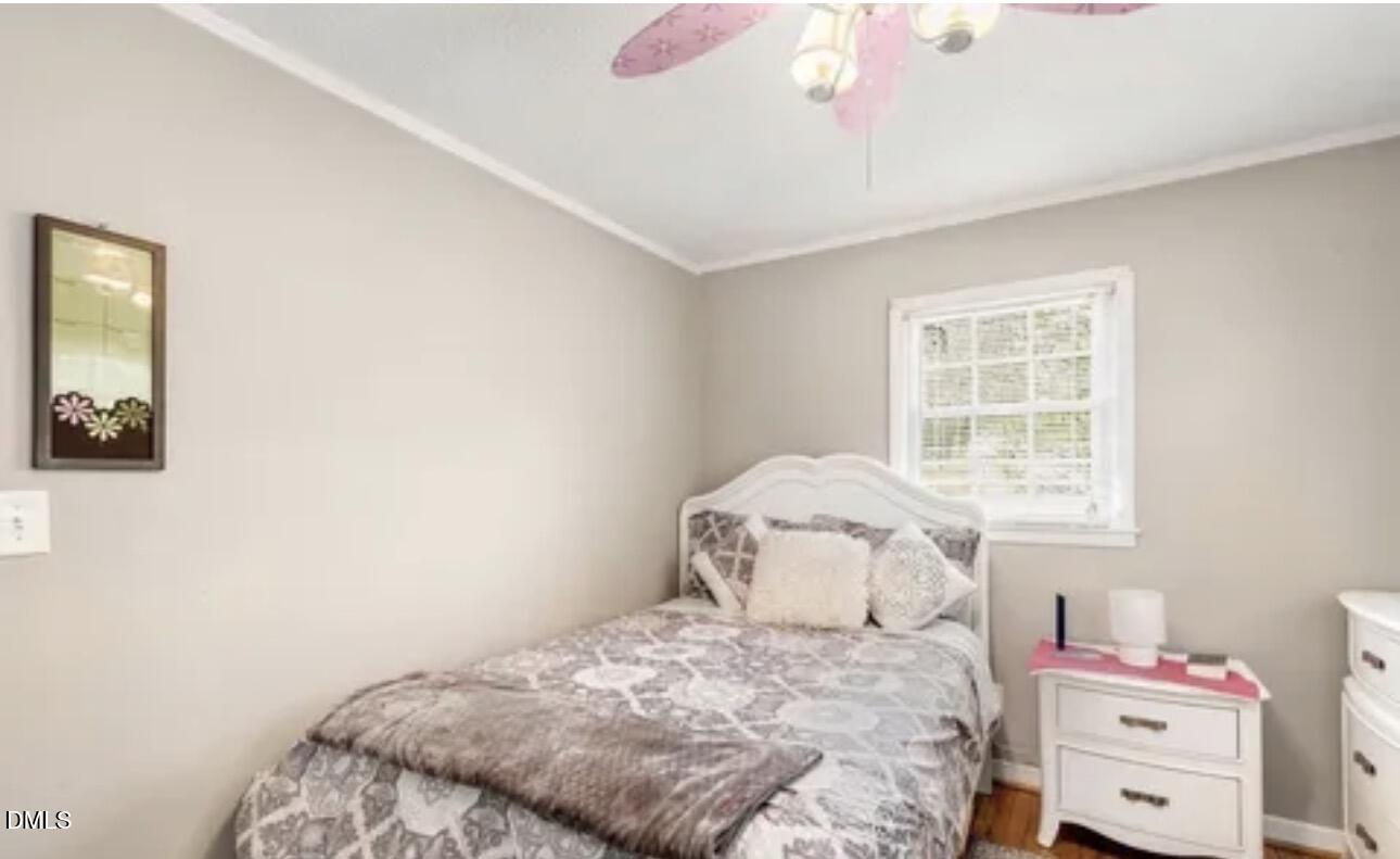 810 Milton Road Durham, NC 27712 - Photo 14 of 21 a bedroom with a bed and a window