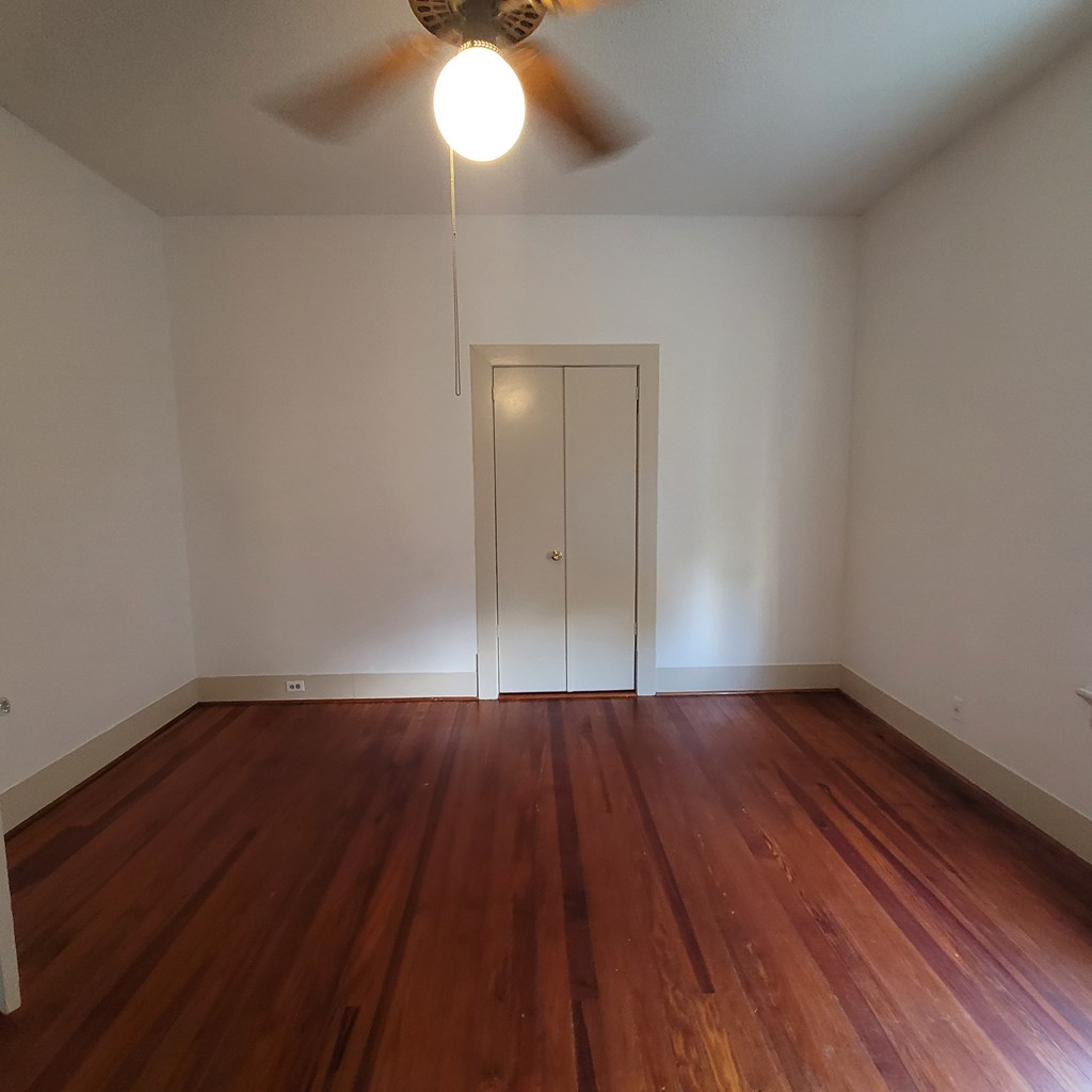 1277 Eberhart Avenue Columbus, GA 31906 - Photo 12 of 17 an empty room with wooden floor and windows