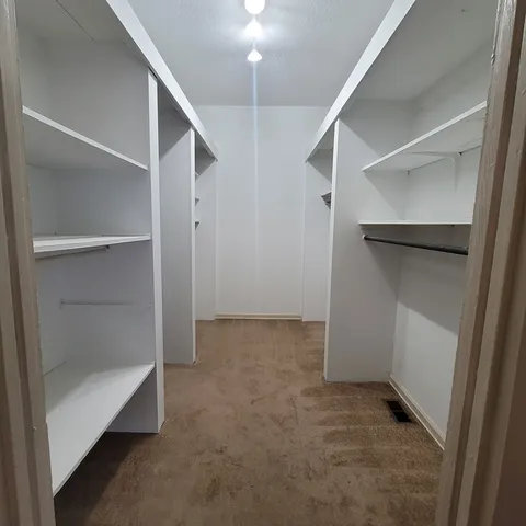 a view of an empty walk in closet