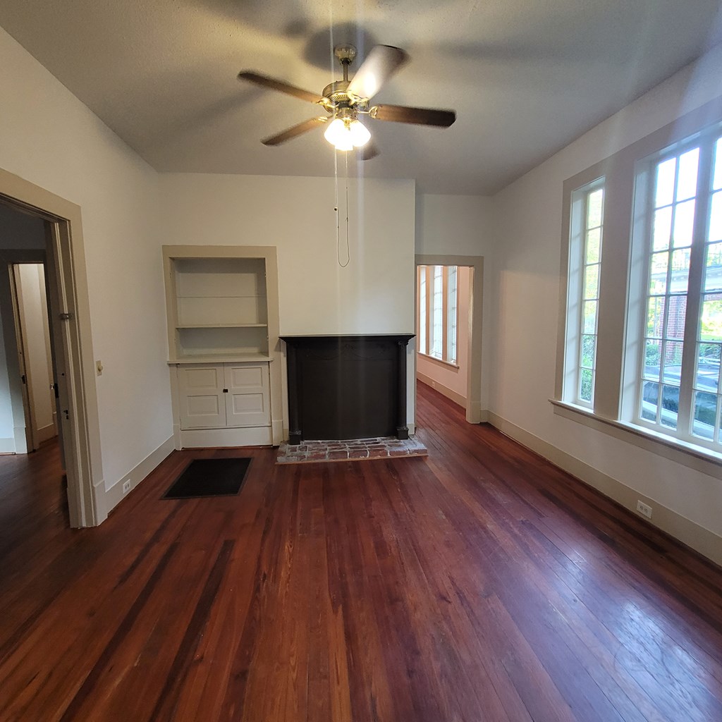 1277 Eberhart Avenue Columbus, GA 31906 - Photo 7 of 17 a view of an empty room with a window and wooden floor