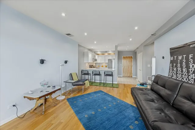a living room with furniture a wooden floor and a table