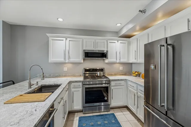 a kitchen with a sink stove and refrigerator