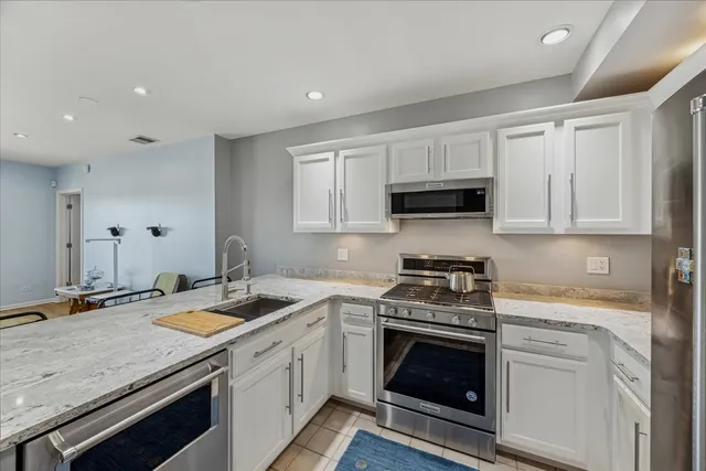 a kitchen with a sink stove and cabinets