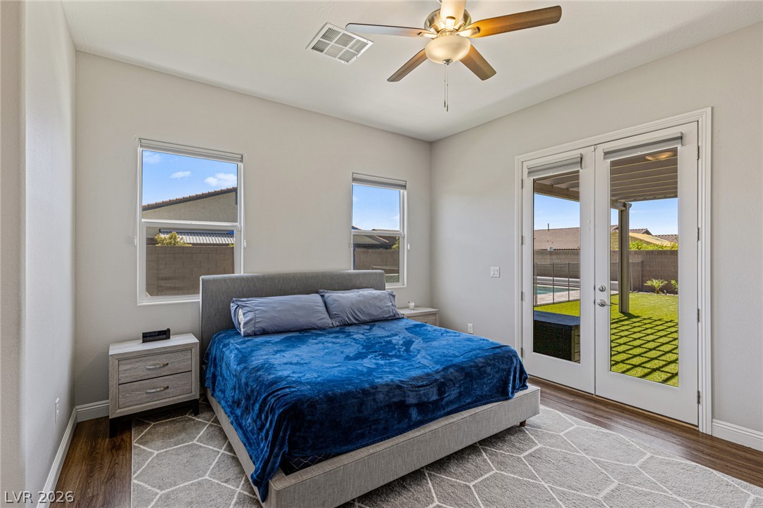 7036 Arabian Ridge Street Las Vegas, NV 89131 - Photo 44 of 64 Large Bedroom 5 with Walk-in closet, ceiling fan and French doors leading out to the covered patio.