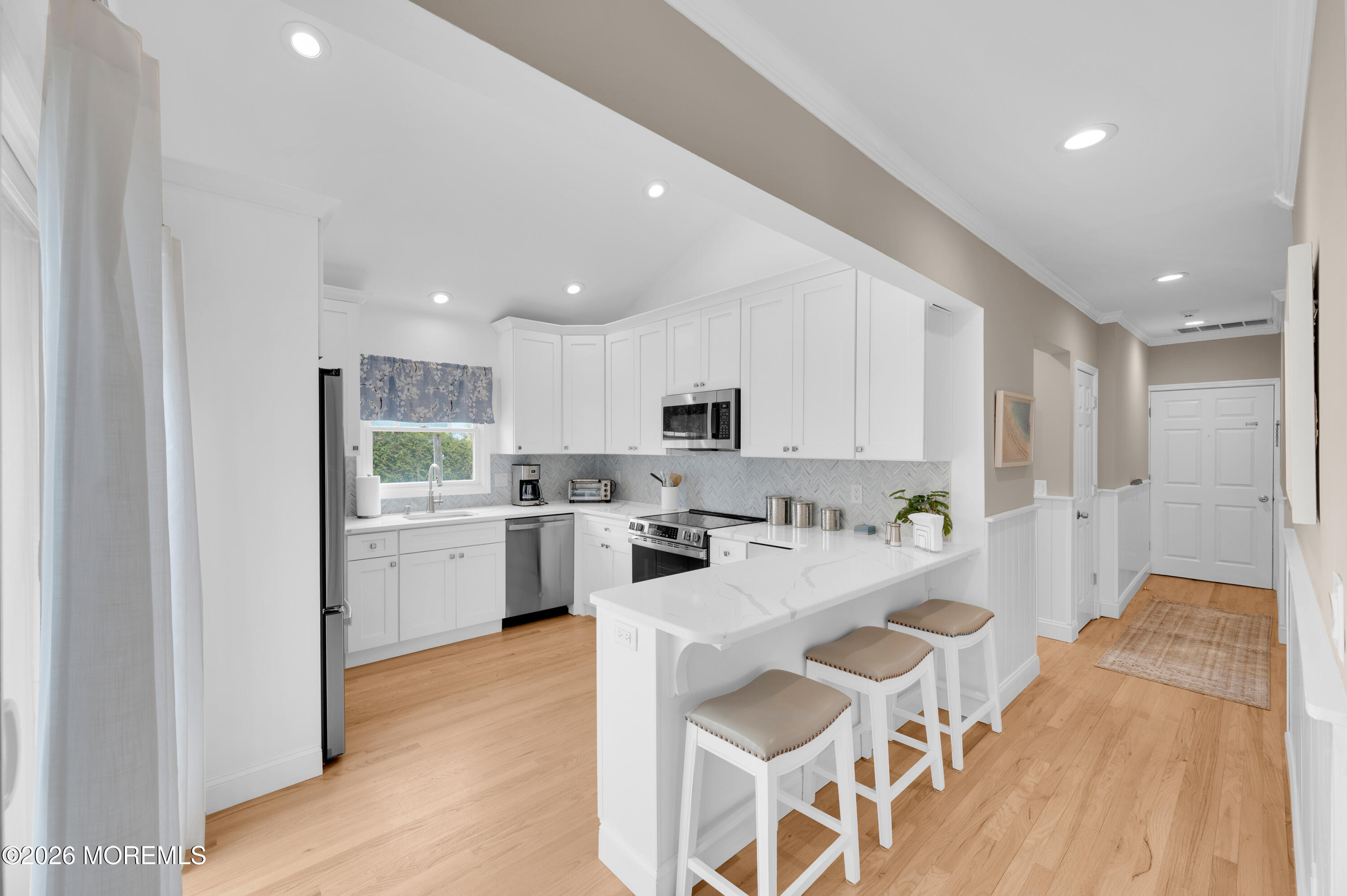 41 A Mount Street Bay Head, NJ 08742 - Photo 5 of 33 a kitchen with white cabinets and stainless steel appliances
