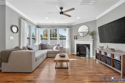 a living room with furniture flat screen tv and a fireplace