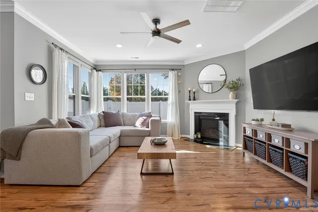 a living room with furniture flat screen tv and a fireplace