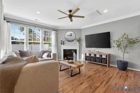 a living room with furniture a fireplace and a flat screen tv