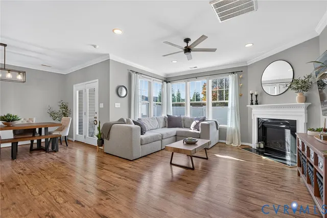 a living room with furniture a fireplace and a large window