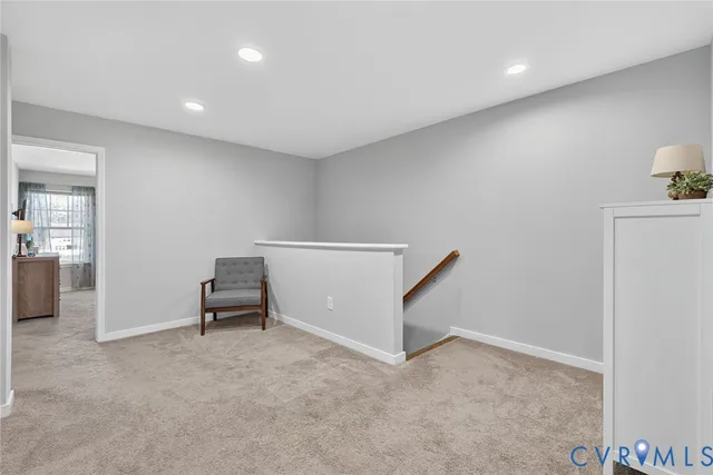 a view of a livingroom with furniture and staircase