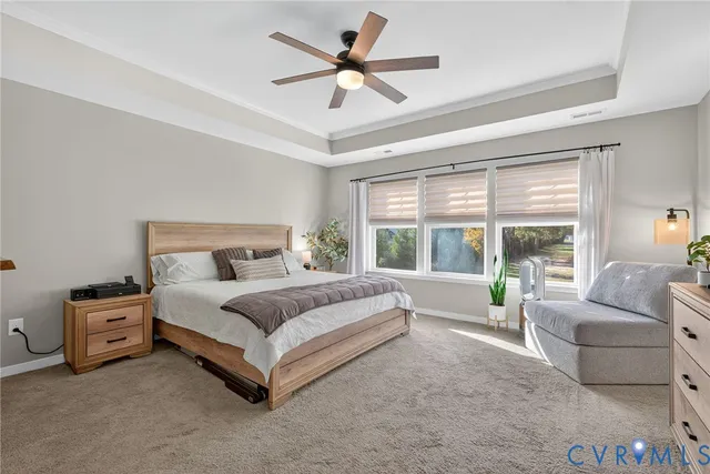 a spacious bedroom with a bed and a large window