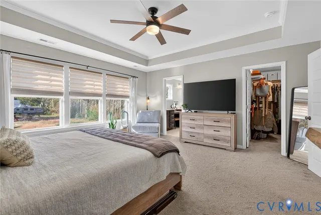 a bedroom with bed tv and window