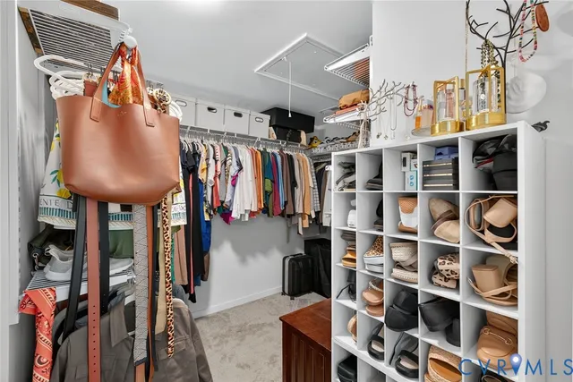 a view of walk in closet with clothes and shoes