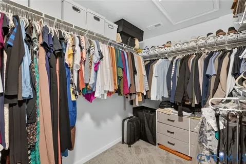 a view of walk in closet with clothes