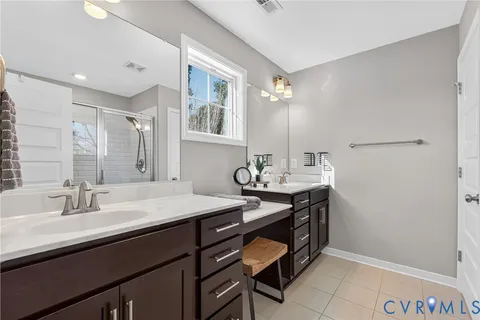 a bathroom with a sink double vanity and a mirror