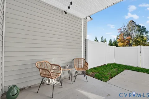 a view of a chairs and table in backyard