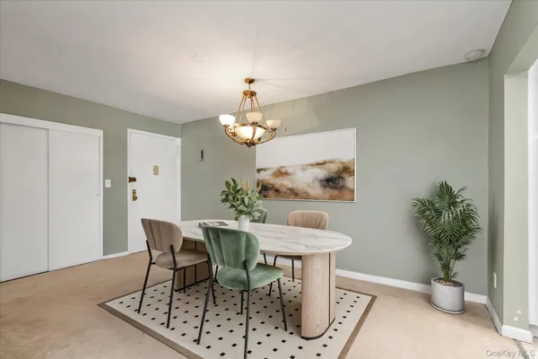 a dining room with furniture and a chandelier
