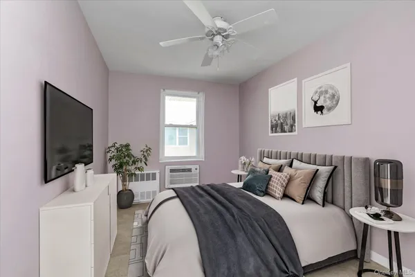 an empty room with windows and ceiling fan