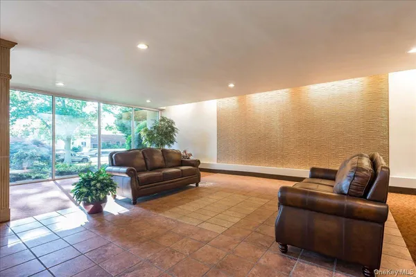 a living room with furniture and a floor to ceiling window