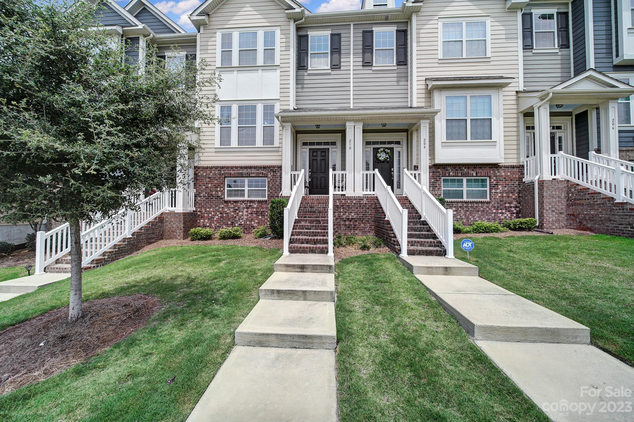 210 Butterfly Place Tega Cay, SC 29708 - Photo 1 of 40 a front view of a house with a yard
