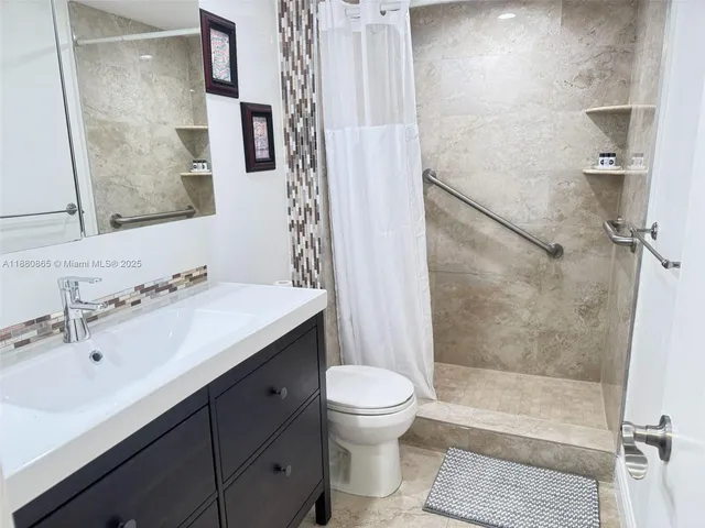 a bathroom with a sink toilet and shower