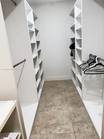 a view of an empty walk in closet with empty racks