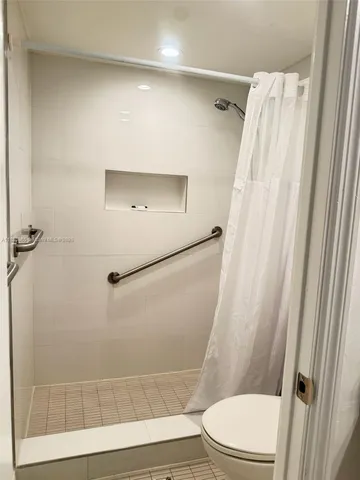 a bathroom with a toilet and a shower