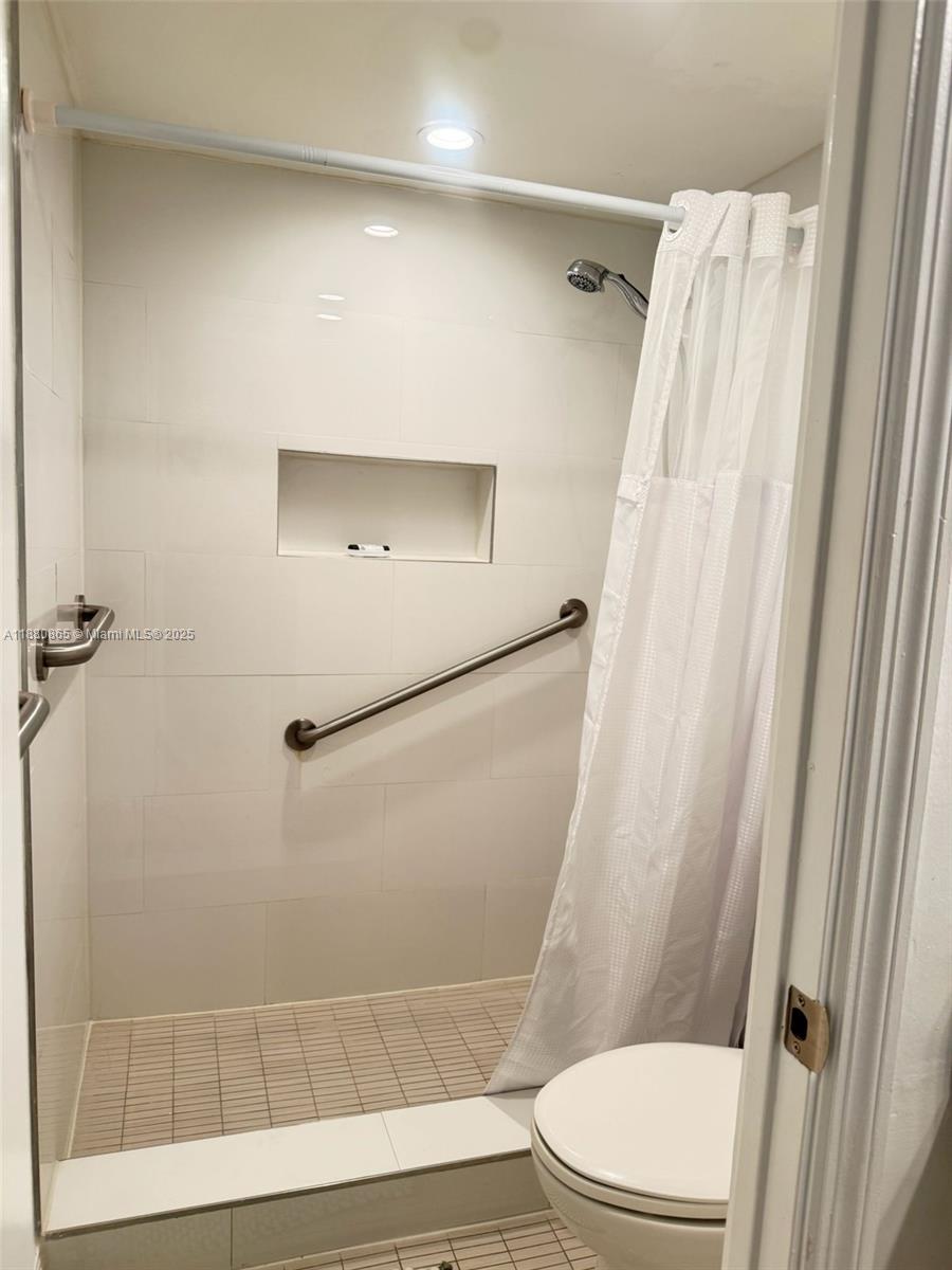 5838 Collins Avenue, Unit 2A Miami Beach, FL 33140 - Photo 10 of 14 a bathroom with a toilet and a shower
