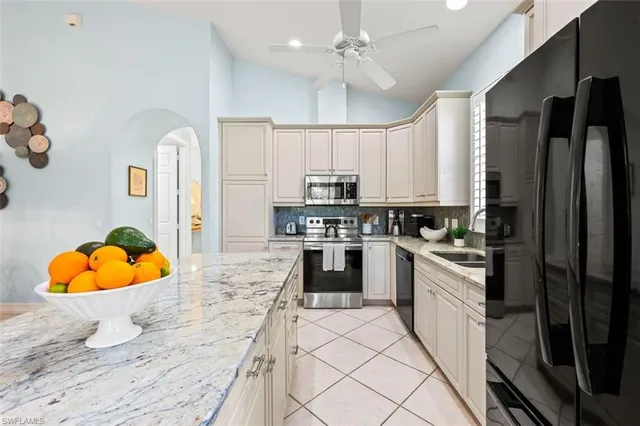 a kitchen with stainless steel appliances granite countertop a stove a sink and a refrigerator